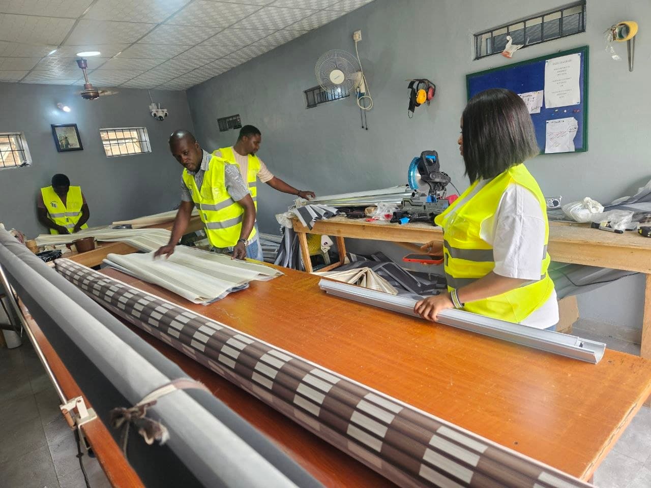 The Bosun Blinds team measuring and assembling blinds at the workbench in their Ibadan workshop